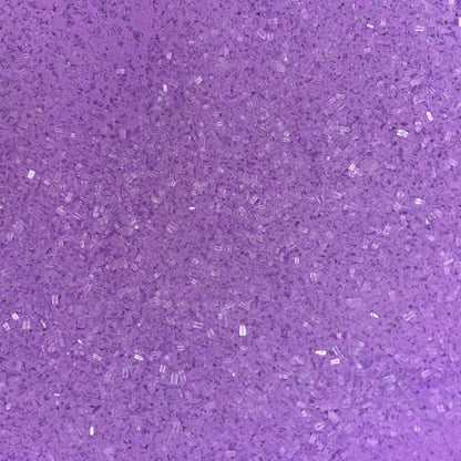 Close-up of fine, bright purple bath soak crystals with a slightly coarse texture and a sparkly, granular appearance